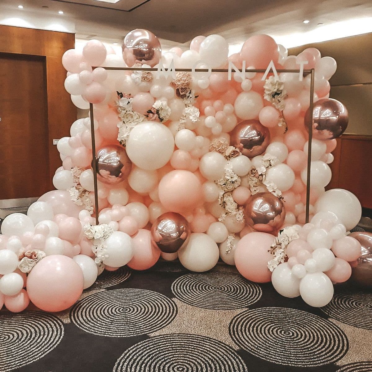 Фотозона из воздушных шаров с дополнительным декором в розовых цветах