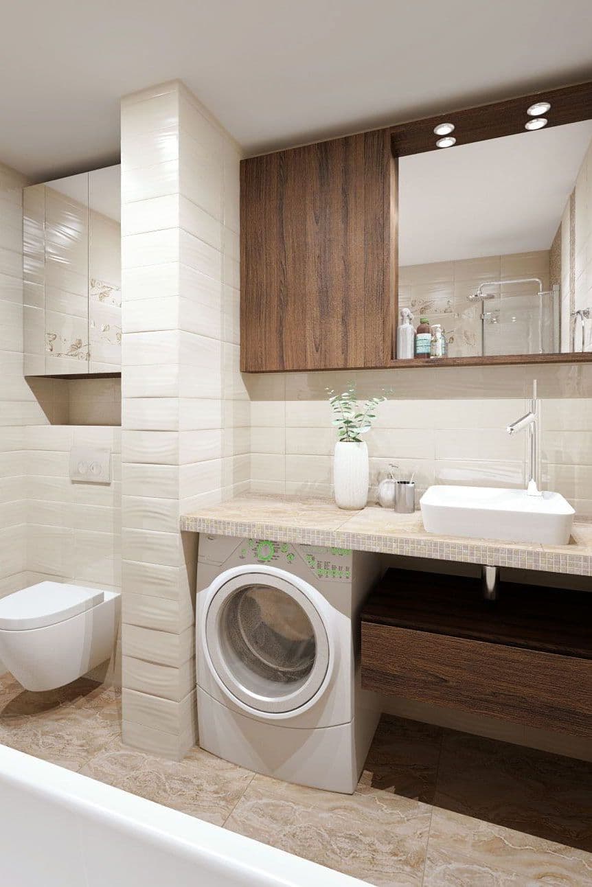 Дизайн интерьера совмещенной ванной комнаты со стиральной машиной, в бежевом цвете с вставками из мозаики и рельефной плиткой, вид на зеркало
